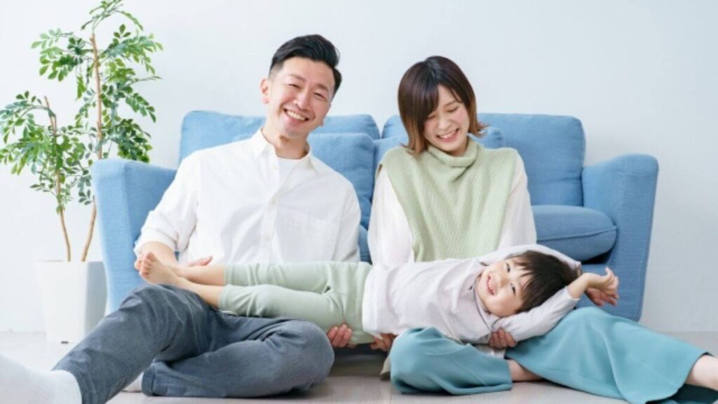 部屋で笑顔で団欒する親子3人