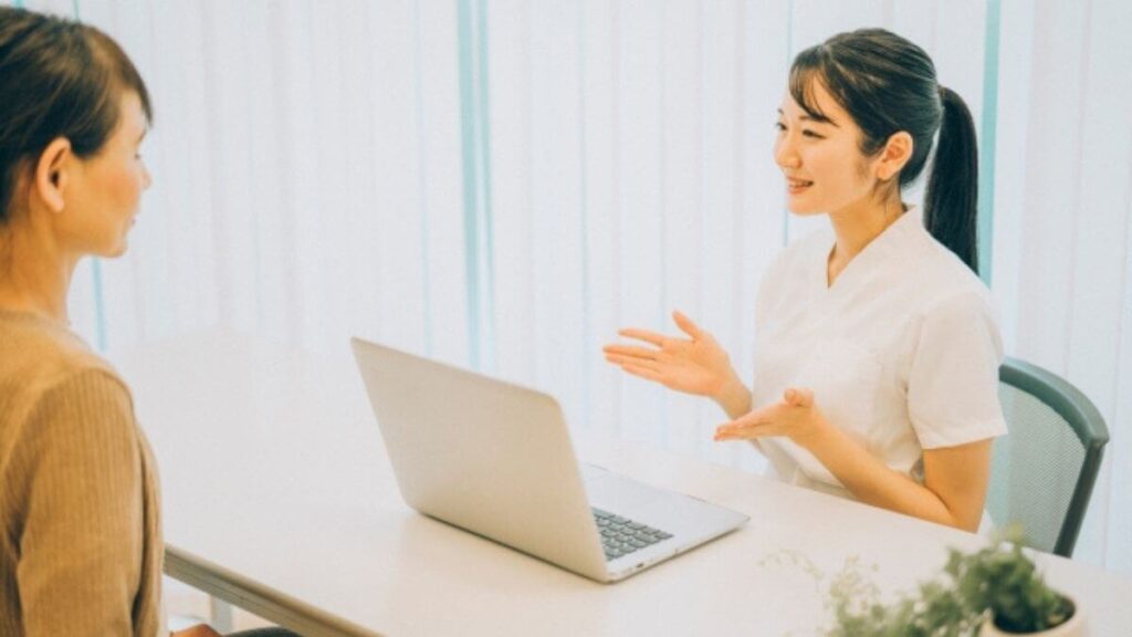 相談者と対面で会話をする女性の心理カウンセラー