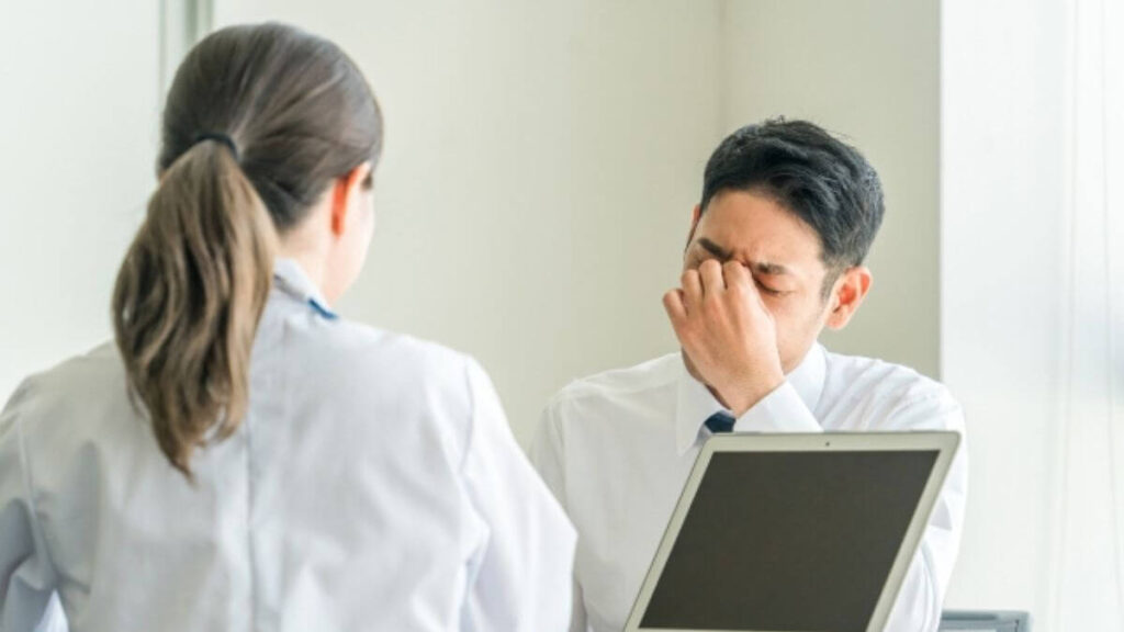 大変そうなサラリーマンから相談を受ける白衣の女性