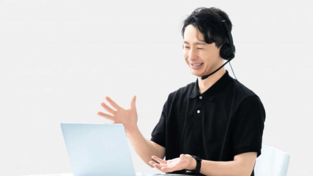 ヘッドセットを使い笑顔で話す男性